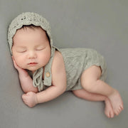 Handcrafted knitted newborn girl outfit, perfect for baby photography with lace details.