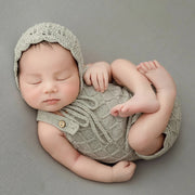 Handcrafted knitted newborn girl outfit, perfect for baby photography with lace details.